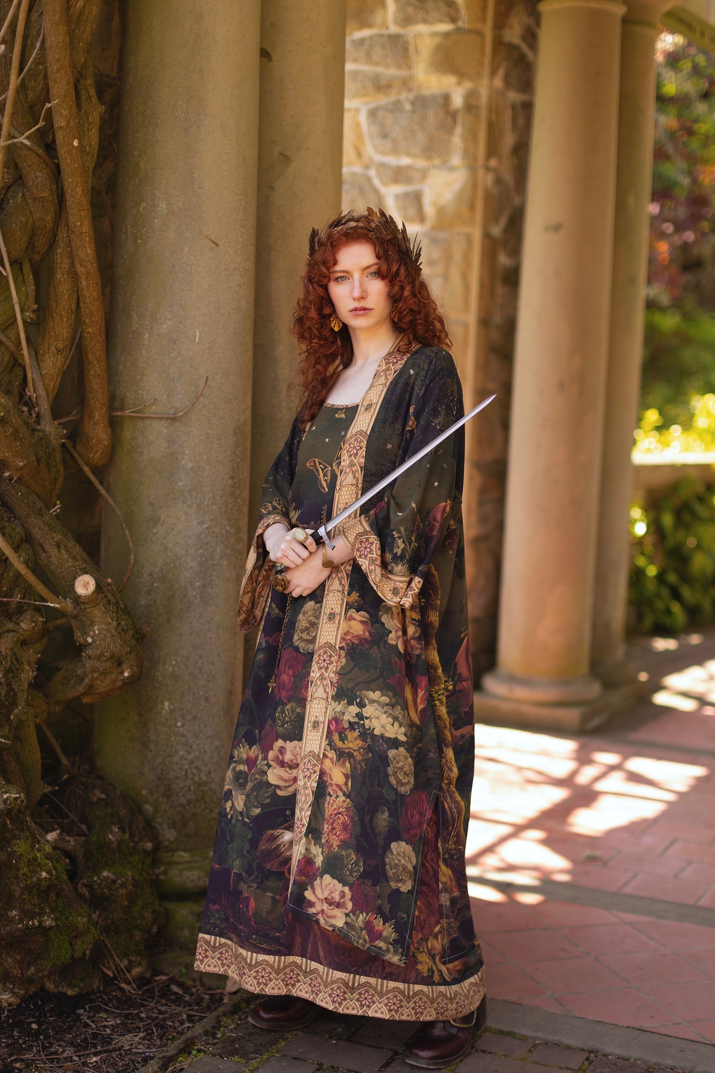 Model wearing a full-length bamboo-viscose duster featuring florals from centuries-old paintings and Rosetti’s iconic portrait of Joan of Arc - Market of Stars