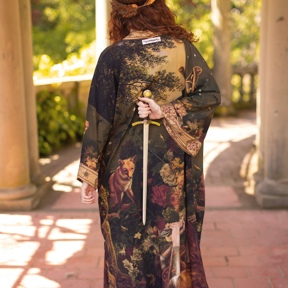 
                  
                    Model wearing a full-length bamboo-viscose duster featuring florals from centuries-old paintings and Rosetti’s iconic portrait of Joan of Arc - Market of Stars
                  
                