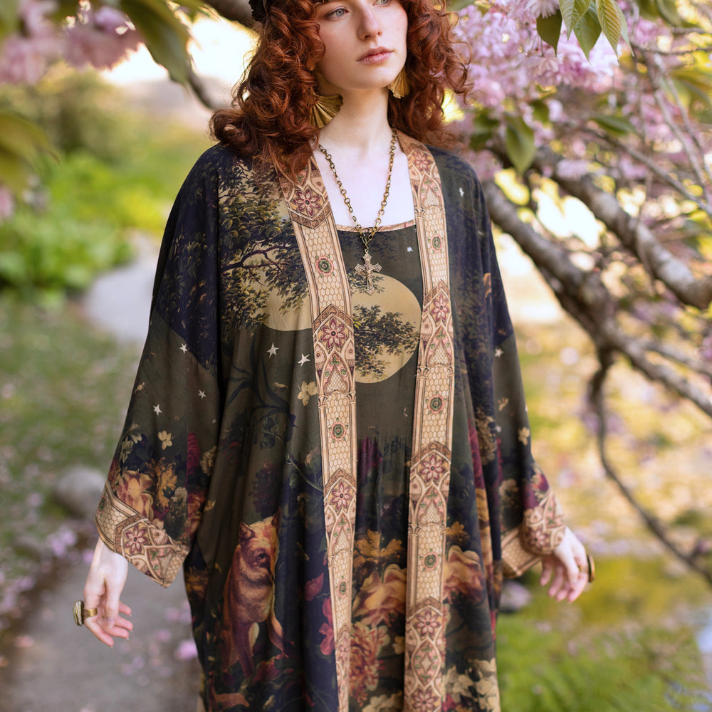 
                  
                    Model wearing a full-length bamboo-viscose duster featuring florals from centuries-old paintings and Rosetti’s iconic portrait of Joan of Arc - Market of Stars
                  
                