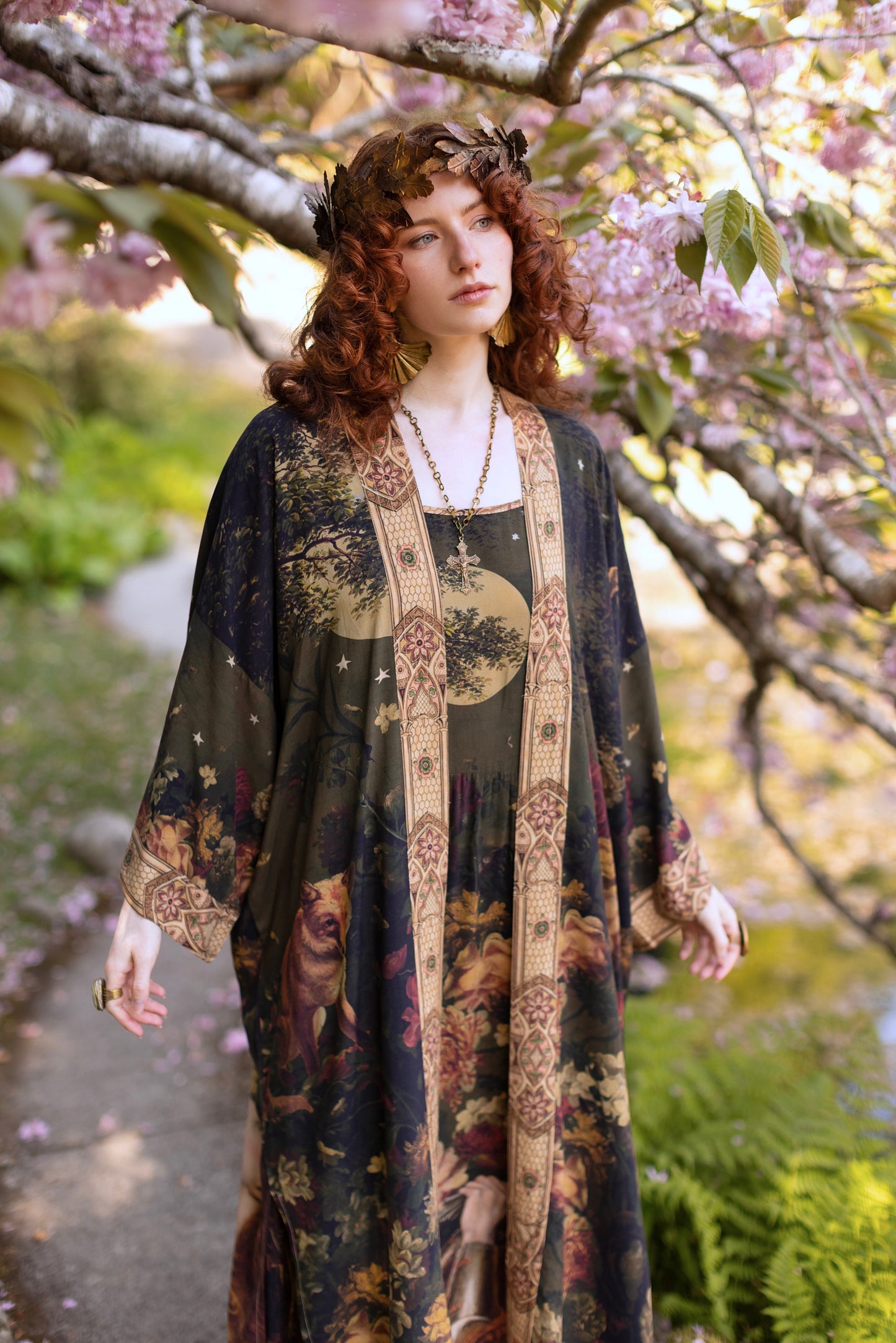 Model wearing a full-length bamboo-viscose duster featuring florals from centuries-old paintings and Rosetti’s iconic portrait of Joan of Arc - Market of Stars