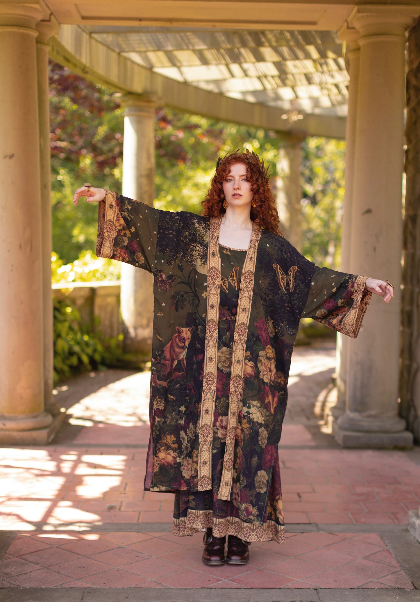 Model wearing a full-length bamboo-viscose duster featuring florals from centuries-old paintings and Rosetti’s iconic portrait of Joan of Arc - Market of Stars