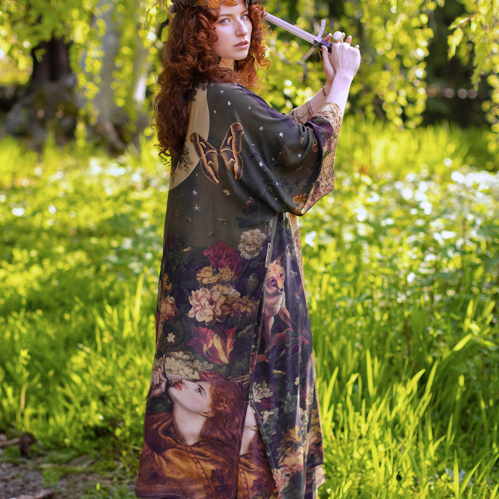 
                  
                    Model wearing a full-length bamboo-viscose duster featuring florals from centuries-old paintings and Rosetti’s iconic portrait of Joan of Arc - Market of Stars
                  
                