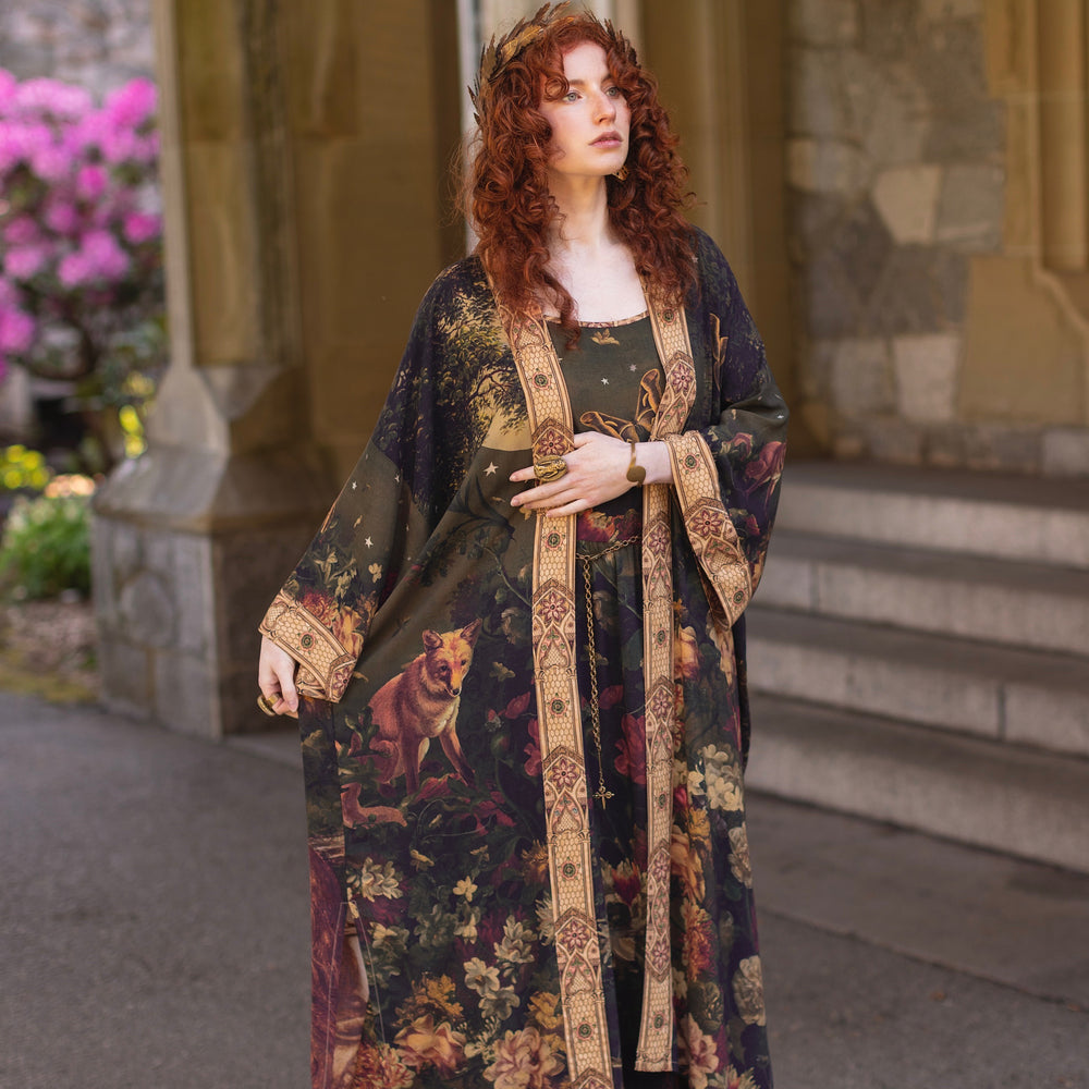 
                  
                    Model wearing a full-length bamboo-viscose duster featuring florals from centuries-old paintings and Rosetti’s iconic portrait of Joan of Arc - Market of Stars
                  
                