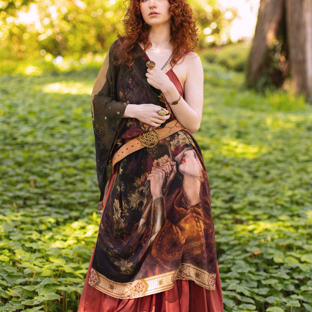 
                  
                    Model wearing a bamboo-viscose scarf featuring florals from centuries-old paintings and Rosetti’s iconic portrait of Joan of Arc - Market of Stars
                  
                