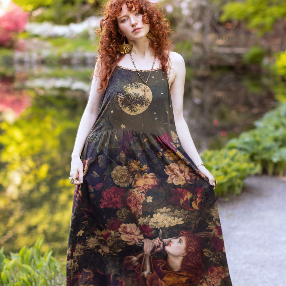 Model wearing a maxi-length bamboo-viscose slip dress featuring florals from centuries-old paintings and Rosetti’s iconic portrait of Joan of Arc - Market of Stars