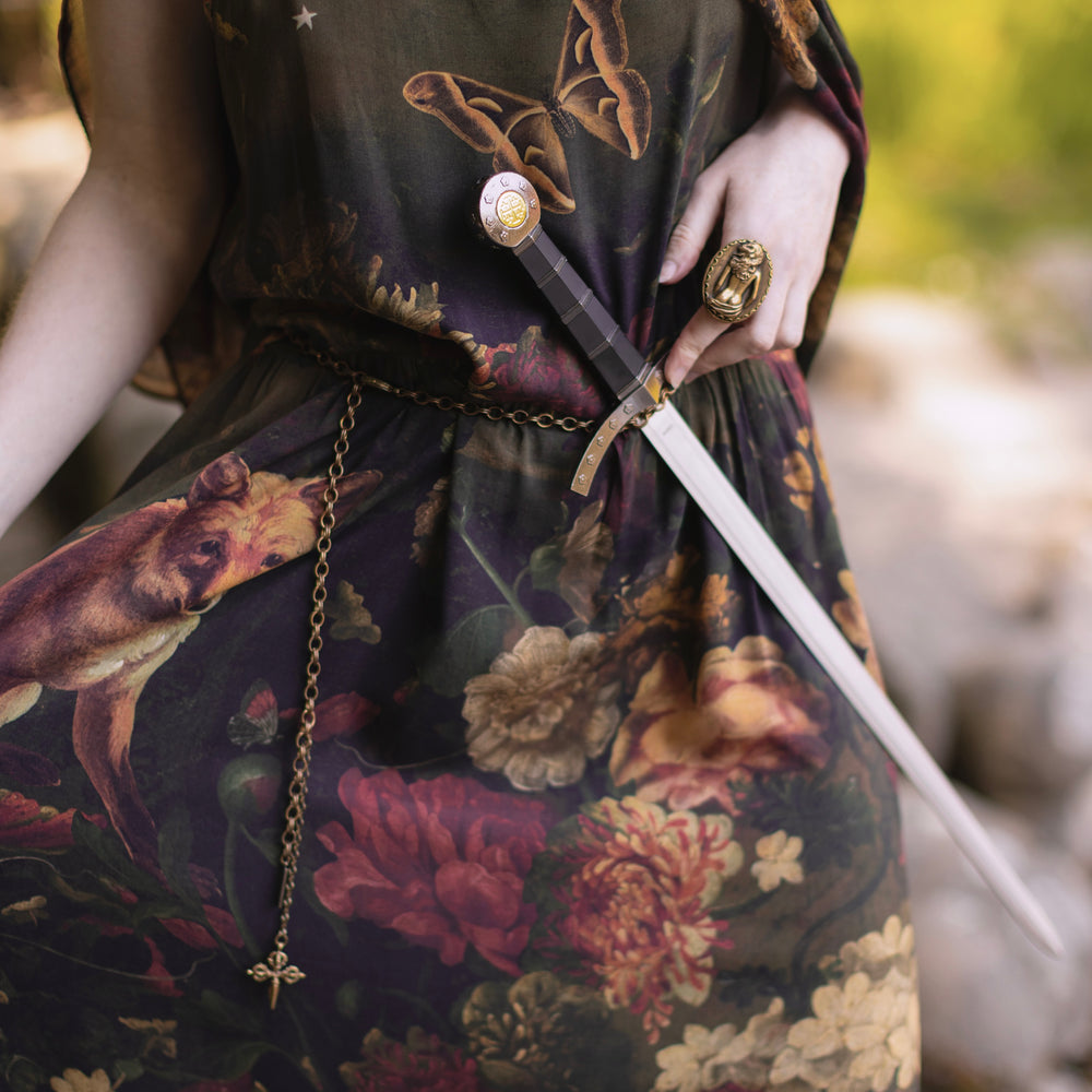 
                  
                    Model wearing a maxi-length bamboo-viscose slip dress featuring florals from centuries-old paintings and Rosetti’s iconic portrait of Joan of Arc - Market of Stars
                  
                