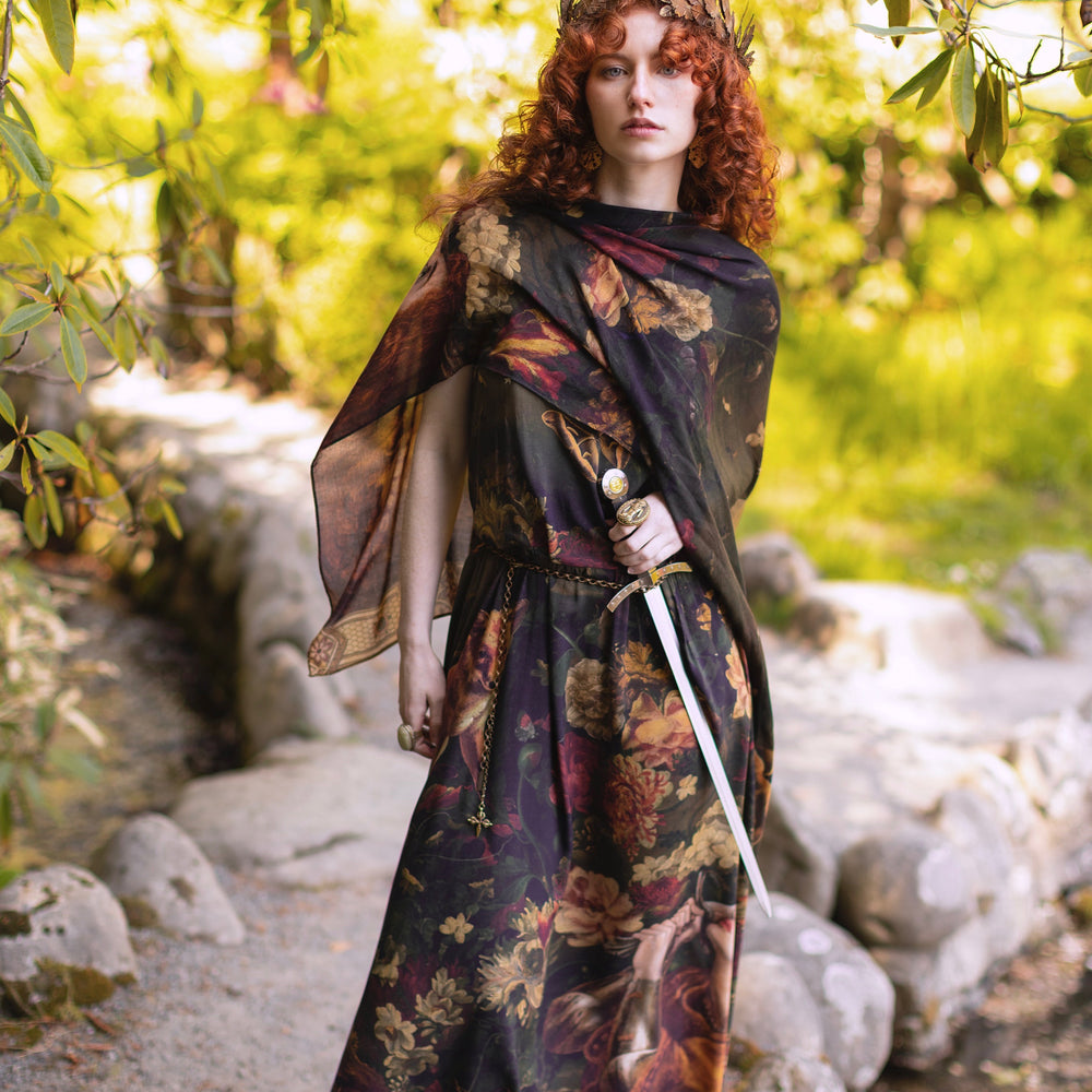 
                  
                    Model wearing a maxi-length bamboo-viscose slip dress featuring florals from centuries-old paintings and Rosetti’s iconic portrait of Joan of Arc - Market of Stars
                  
                
