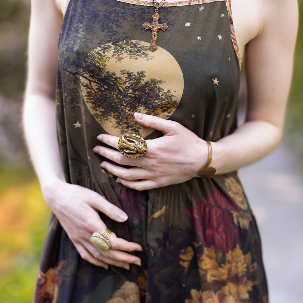 
                  
                    Model wearing a maxi-length bamboo-viscose slip dress featuring florals from centuries-old paintings and Rosetti’s iconic portrait of Joan of Arc - Market of Stars
                  
                
