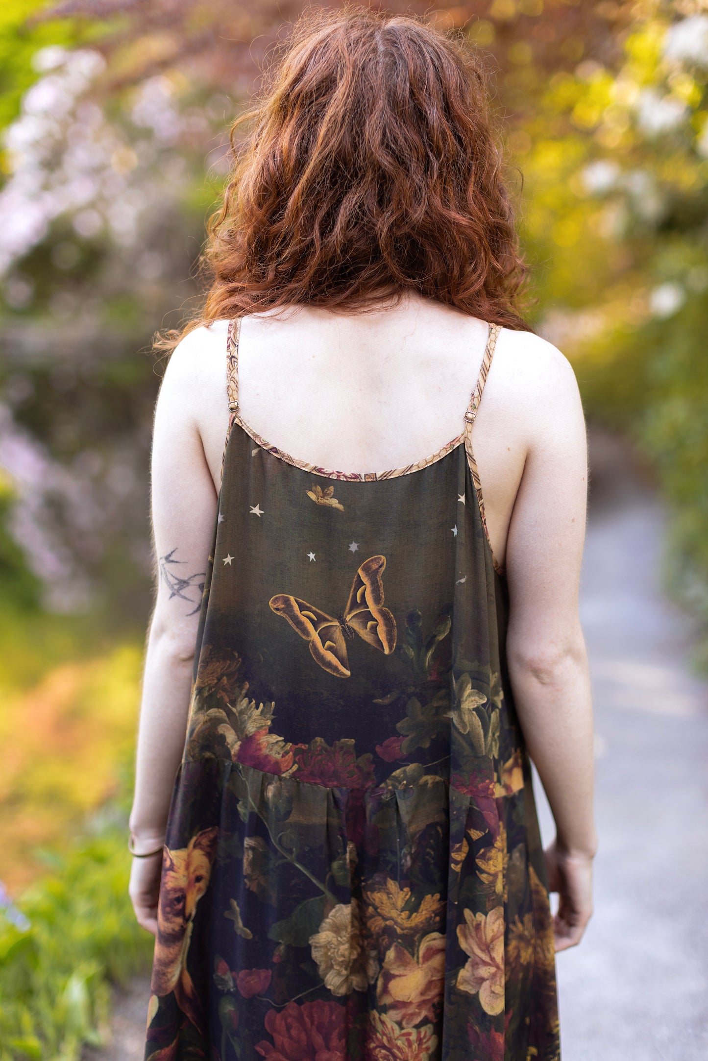 Model wearing a maxi-length bamboo-viscose slip dress featuring florals from centuries-old paintings and Rosetti’s iconic portrait of Joan of Arc - Market of Stars