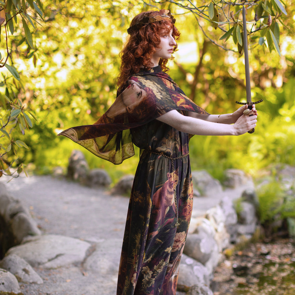 
                  
                    Model wearing a maxi-length bamboo-viscose slip dress featuring florals from centuries-old paintings and Rosetti’s iconic portrait of Joan of Arc - Market of Stars
                  
                
