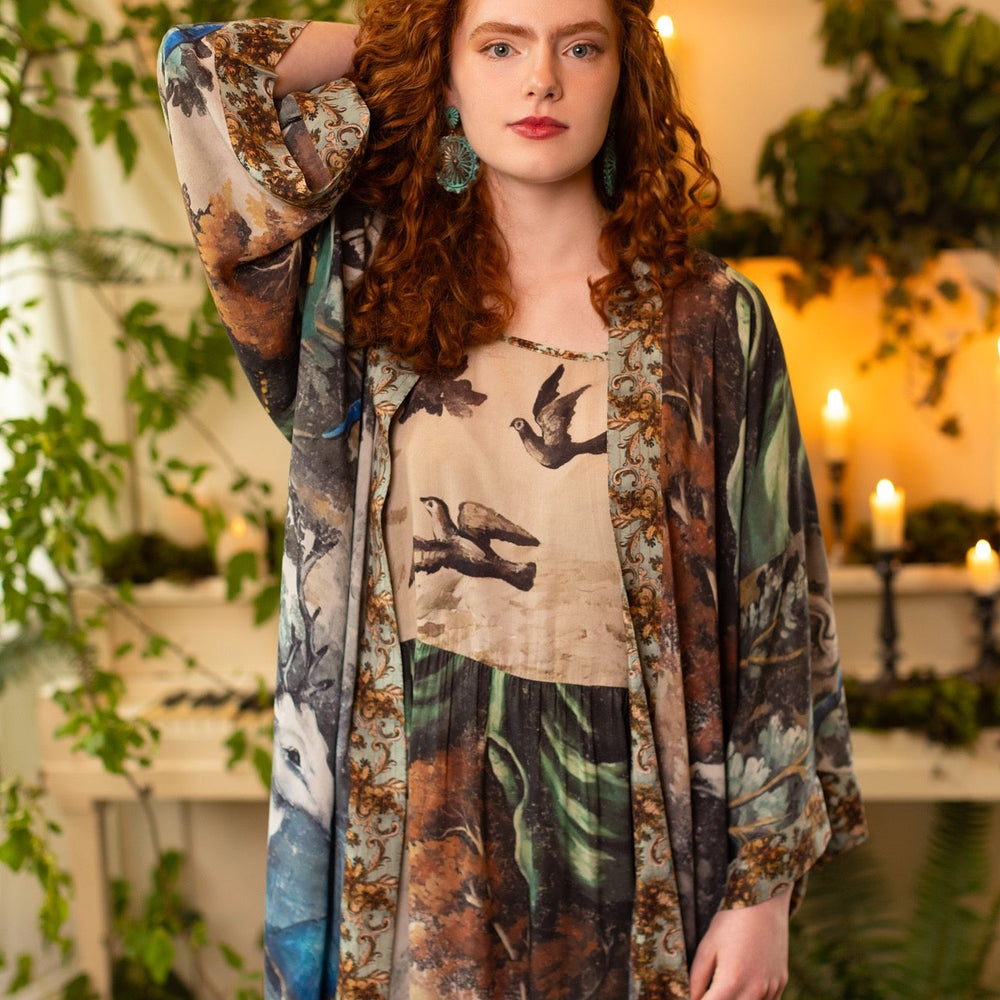 
                  
                    Model wearing our Theatre of Dreams Slip Dress featuring whimsical deer and birds from Jennifer Lanne’s romantic paintings – Market of Stars
                  
                