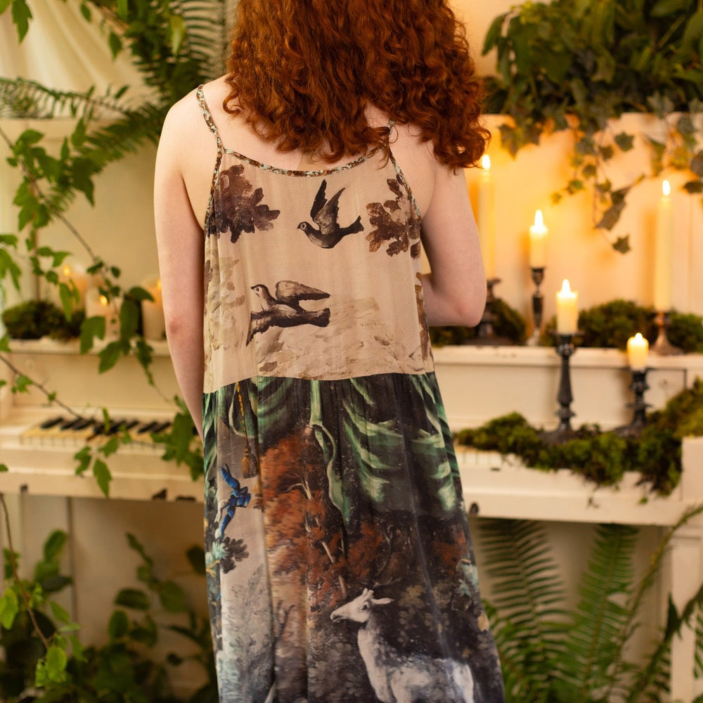 
                  
                    Model wearing our Theatre of Dreams Slip Dress featuring whimsical deer and birds from Jennifer Lanne’s romantic paintings – Market of Stars
                  
                