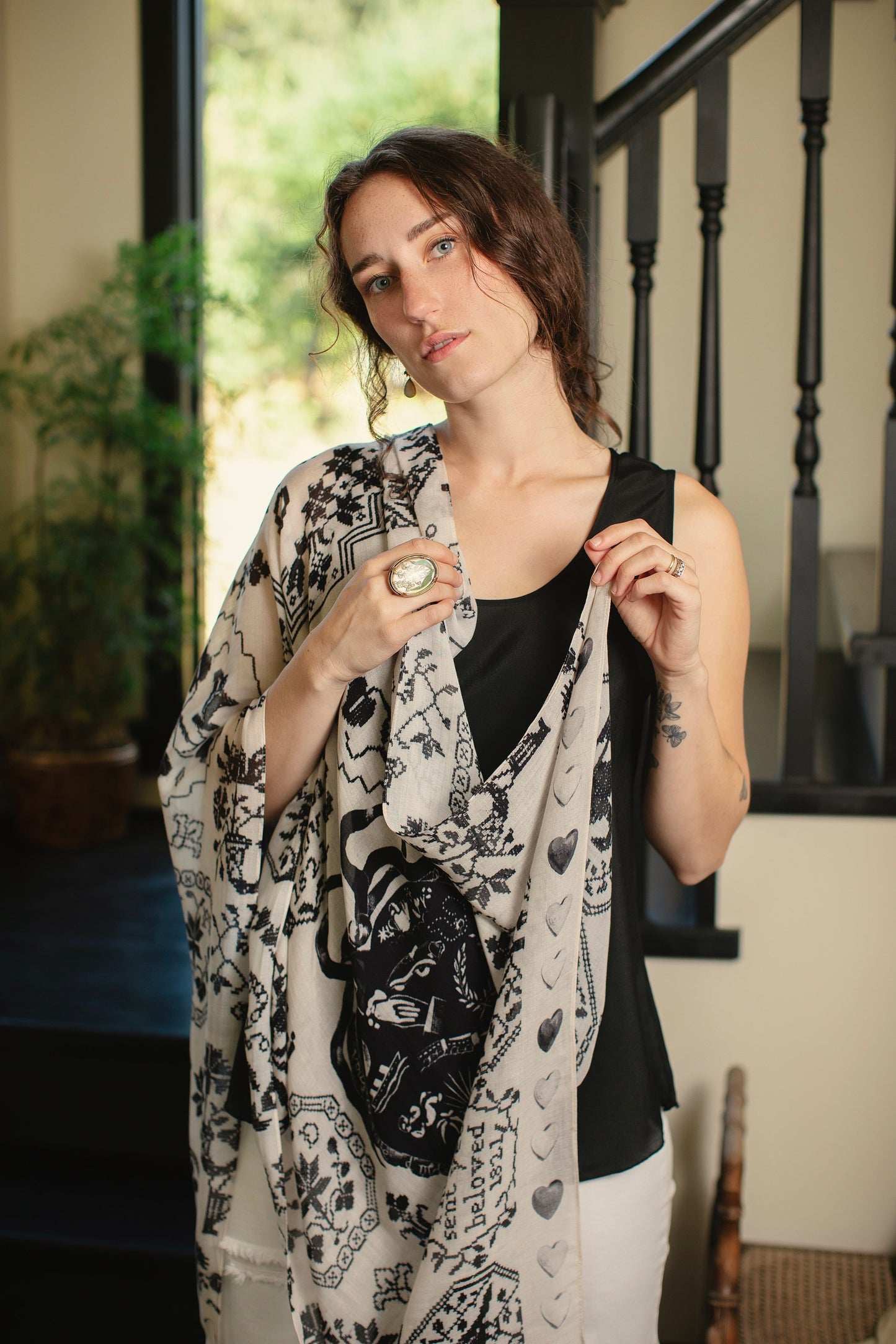 Model wearing the Token of Love scarf featuring black and ivory printed antique cross-stitch – Market of Stars