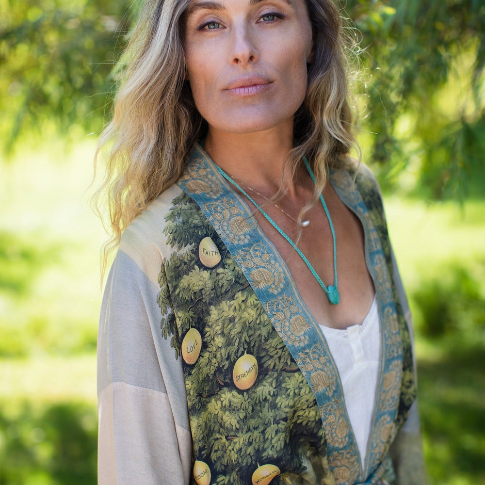 
                  
                    Model wearing Tree of Life Matinée Duster in aquas and verdant greens inspired by antique textiles – Market of Stars
                  
                