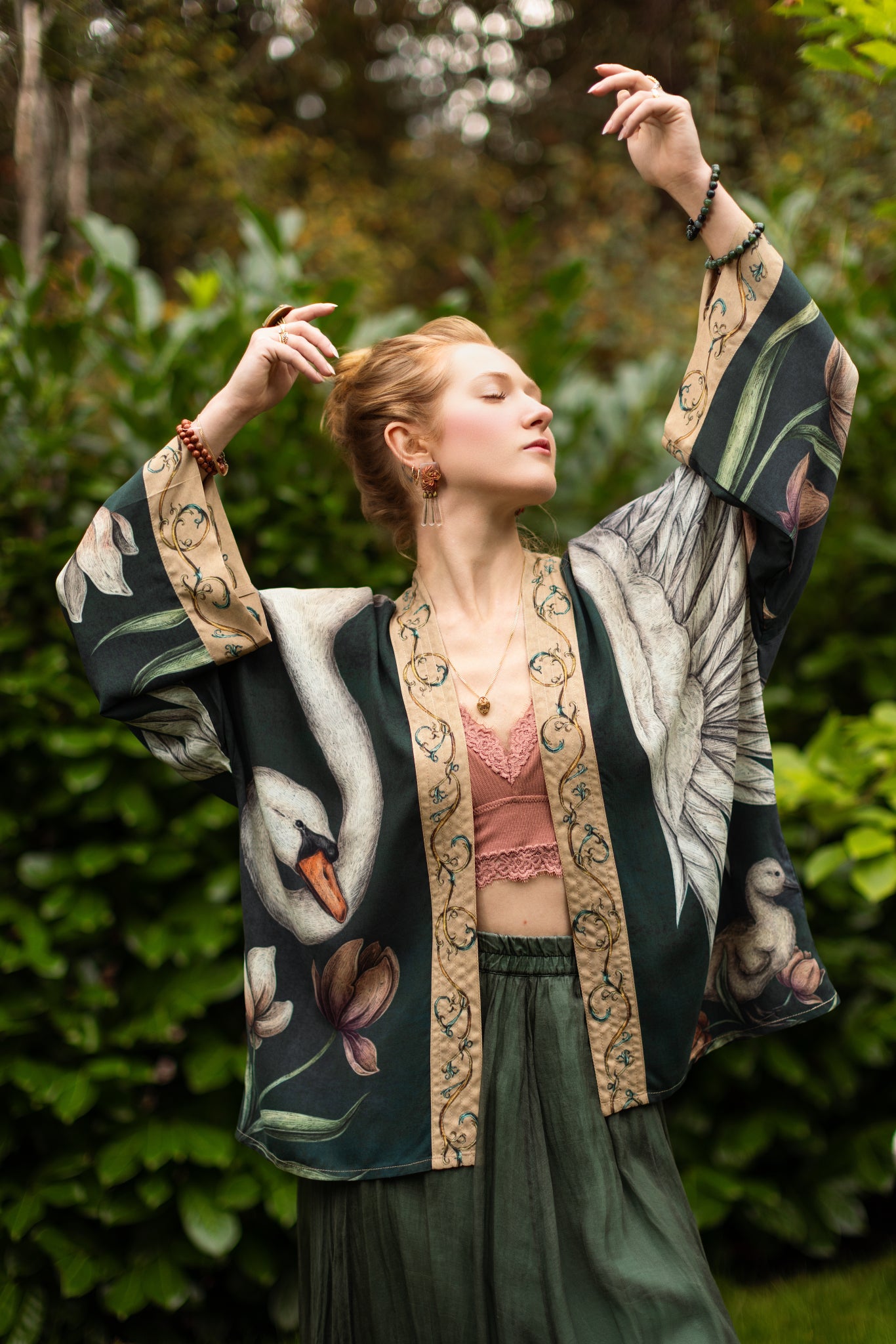 Model wearing a cropped-length duster created in collaboration with artist Jessica Roux and features a trompe l'oeil swan symbolizing protection, love, and grace - Market of Stars.