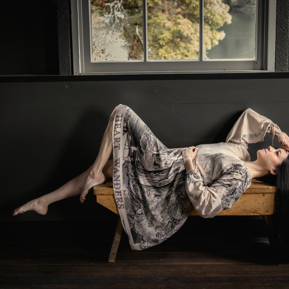 
                  
                    Model wearing knee-length dress with long sleeves featuring vintage print of a forest, songbirds and sunshine - Market of Stars
                  
                