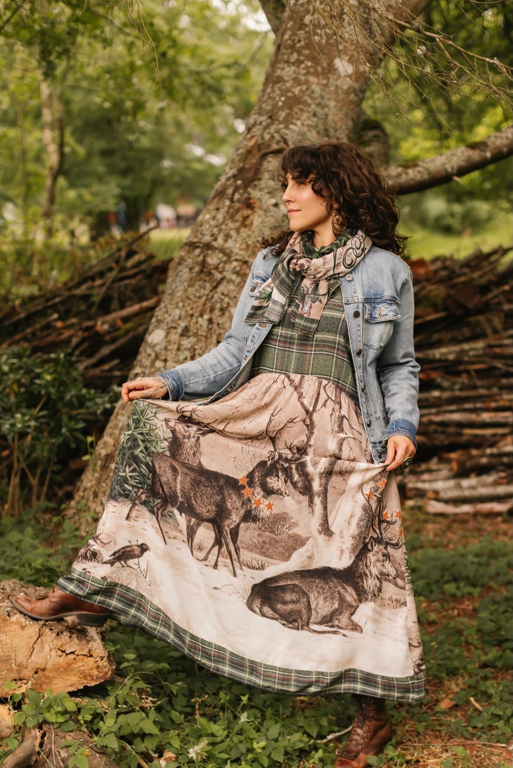 Model wearing a bamboo viscose maxi slip dress with Victorian-era images from holiday greeting cards — including reindeer in the snow, a little fir tree, golden stars, and traditional plaid trim - Market of Stars