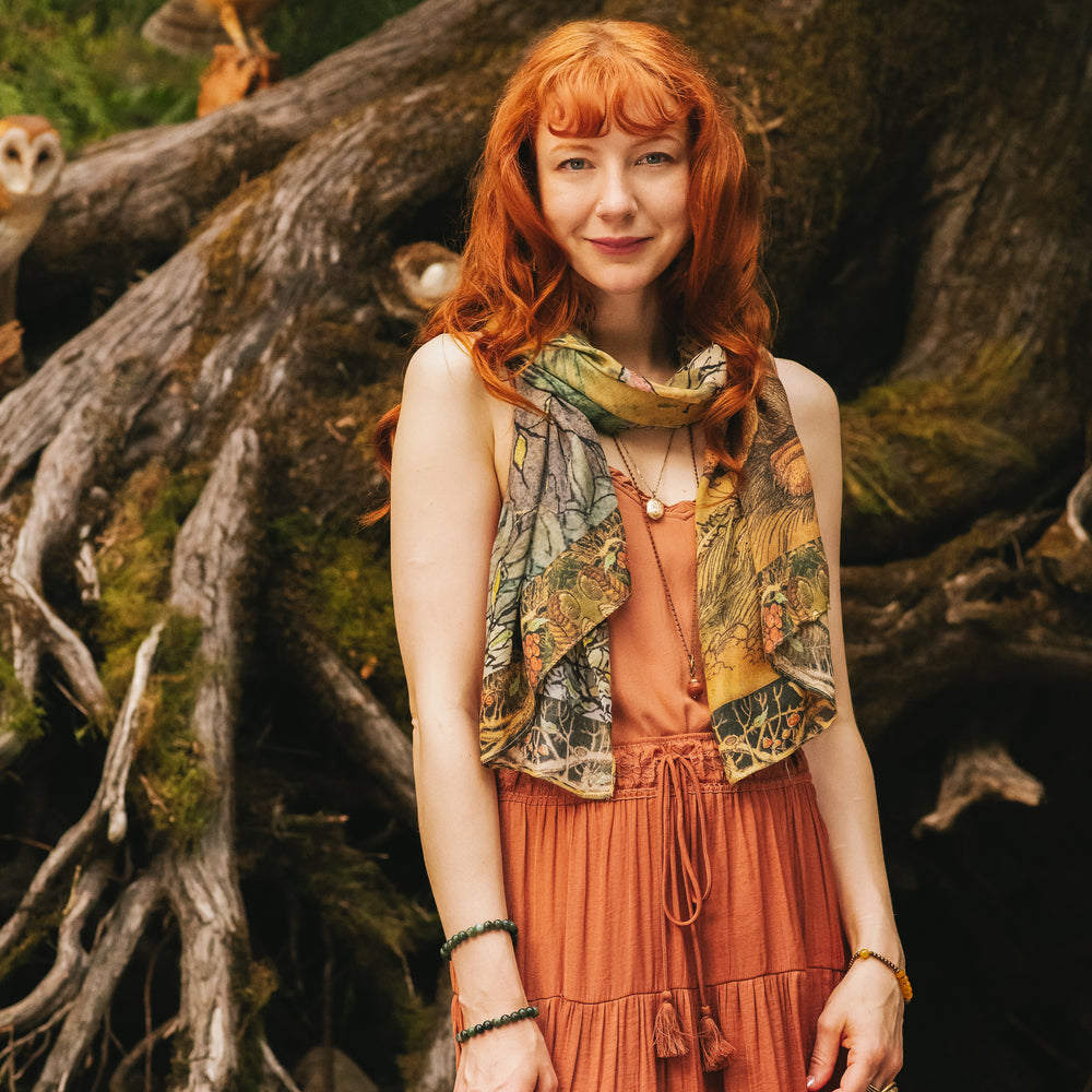
                  
                    Model wearing a bamboo-viscose scarf where a noble rabbit rests deep within an underground burrow, surrounded by the warmth and safety of the earth. Created in collaboration with Charles van Sandwyck - Market of Stars
                  
                