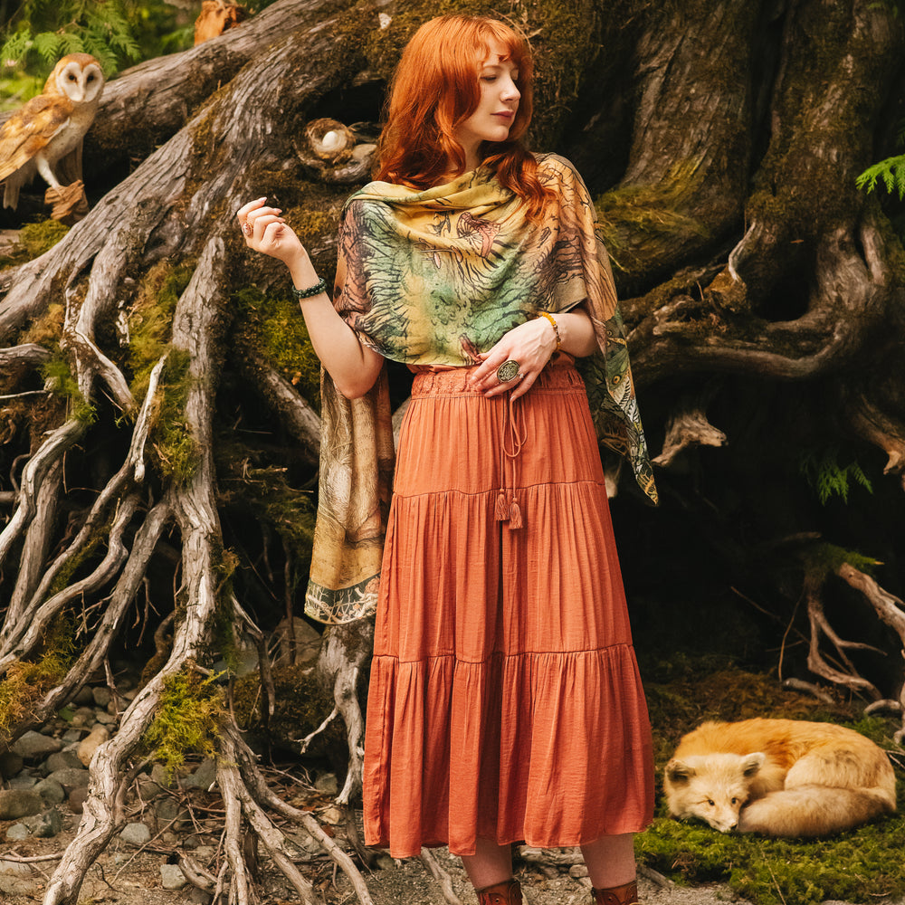 
                  
                    Model wearing a bamboo-viscose scarf where a noble rabbit rests deep within an underground burrow, surrounded by the warmth and safety of the earth. Created in collaboration with Charles van Sandwyck - Market of Stars
                  
                