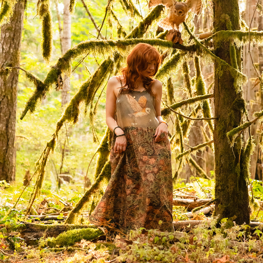 
                  
                    Model wearing a bamboo-viscose maxi length slip dress where even the unlikeliest of friends...a fox and a pheasant...find warmth in each other’s company. Created in collaboration with Charles van Sandwyck - Market of Stars
                  
                