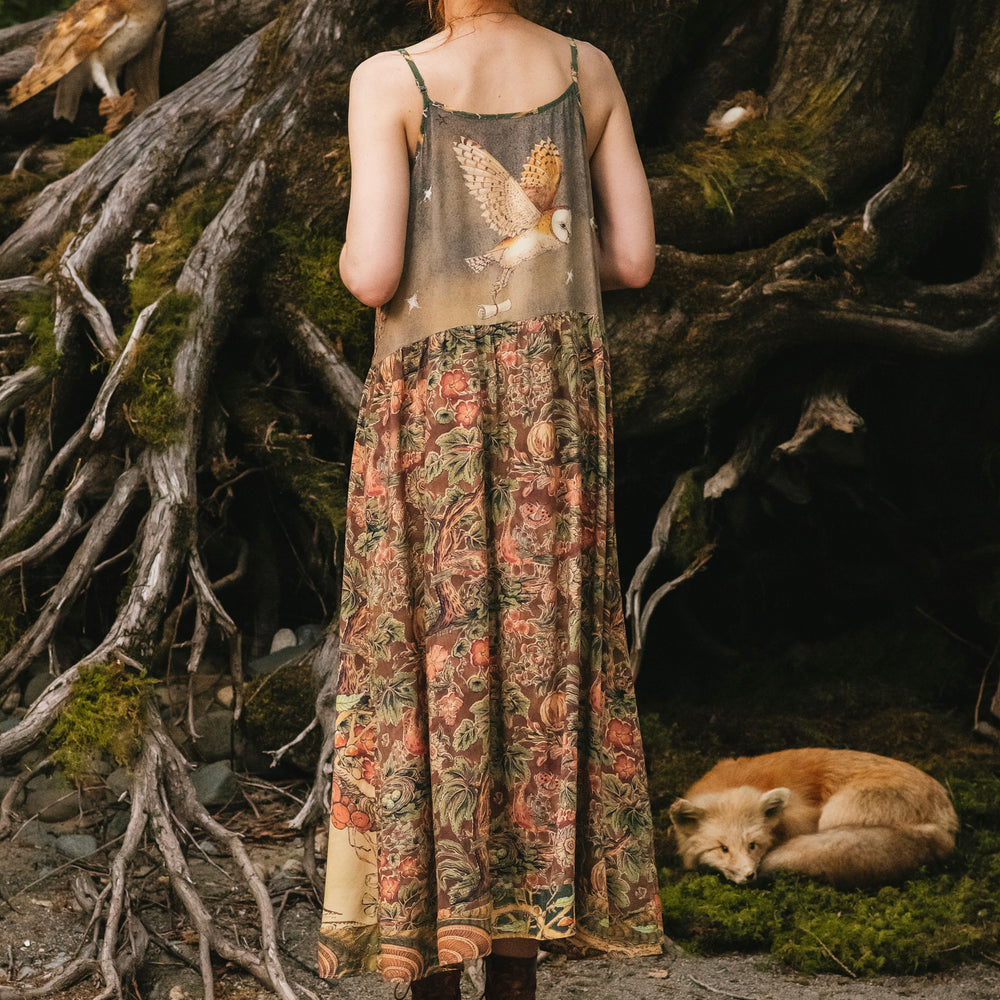 
                  
                    Model wearing a bamboo-viscose maxi length slip dress where even the unlikeliest of friends...a fox and a pheasant...find warmth in each other’s company. Created in collaboration with Charles van Sandwyck - Market of Stars
                  
                