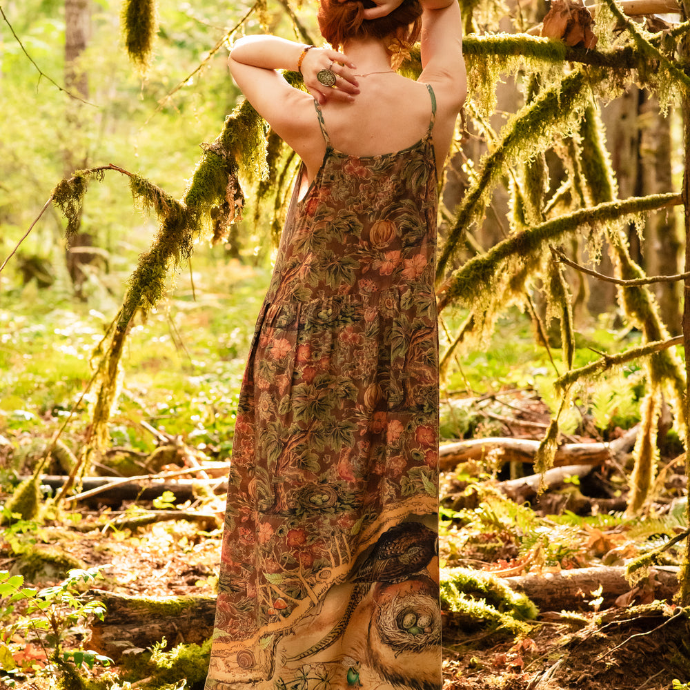 
                  
                    Model wearing a bamboo-viscose maxi length slip dress where even the unlikeliest of friends...a fox and a pheasant...find warmth in each other’s company. Created in collaboration with Charles van Sandwyck - Market of Stars
                  
                