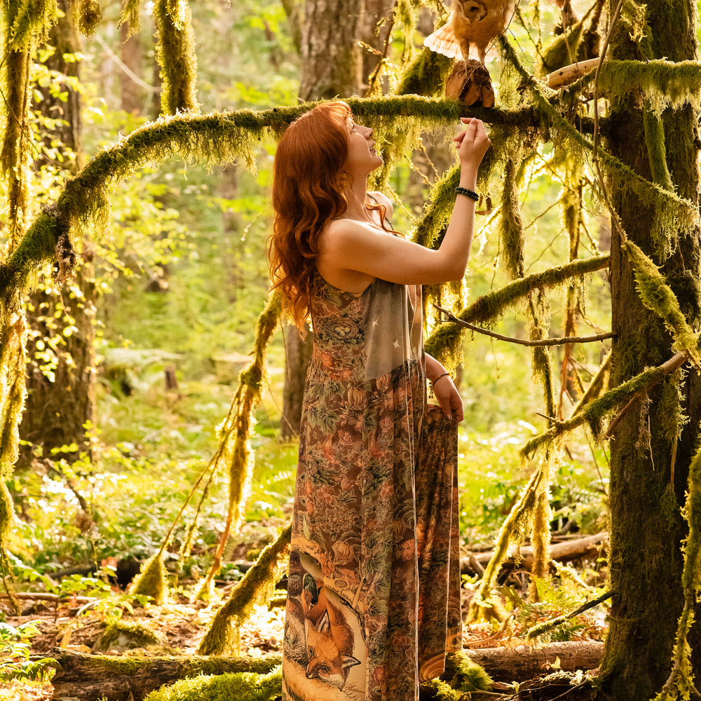 
                  
                    Model wearing a bamboo-viscose maxi length slip dress where even the unlikeliest of friends...a fox and a pheasant...find warmth in each other’s company. Created in collaboration with Charles van Sandwyck - Market of Stars
                  
                