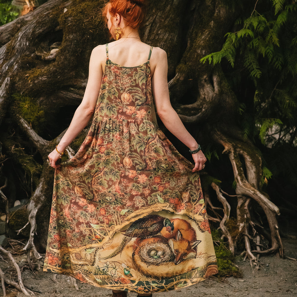 
                  
                    Model wearing a bamboo-viscose maxi length slip dress where even the unlikeliest of friends...a fox and a pheasant...find warmth in each other’s company. Created in collaboration with Charles van Sandwyck - Market of Stars
                  
                