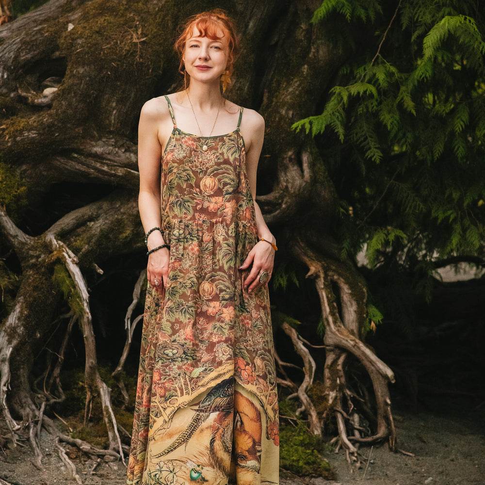 
                  
                    Model wearing a bamboo-viscose maxi length slip dress where even the unlikeliest of friends...a fox and a pheasant...find warmth in each other’s company. Created in collaboration with Charles van Sandwyck - Market of Stars
                  
                