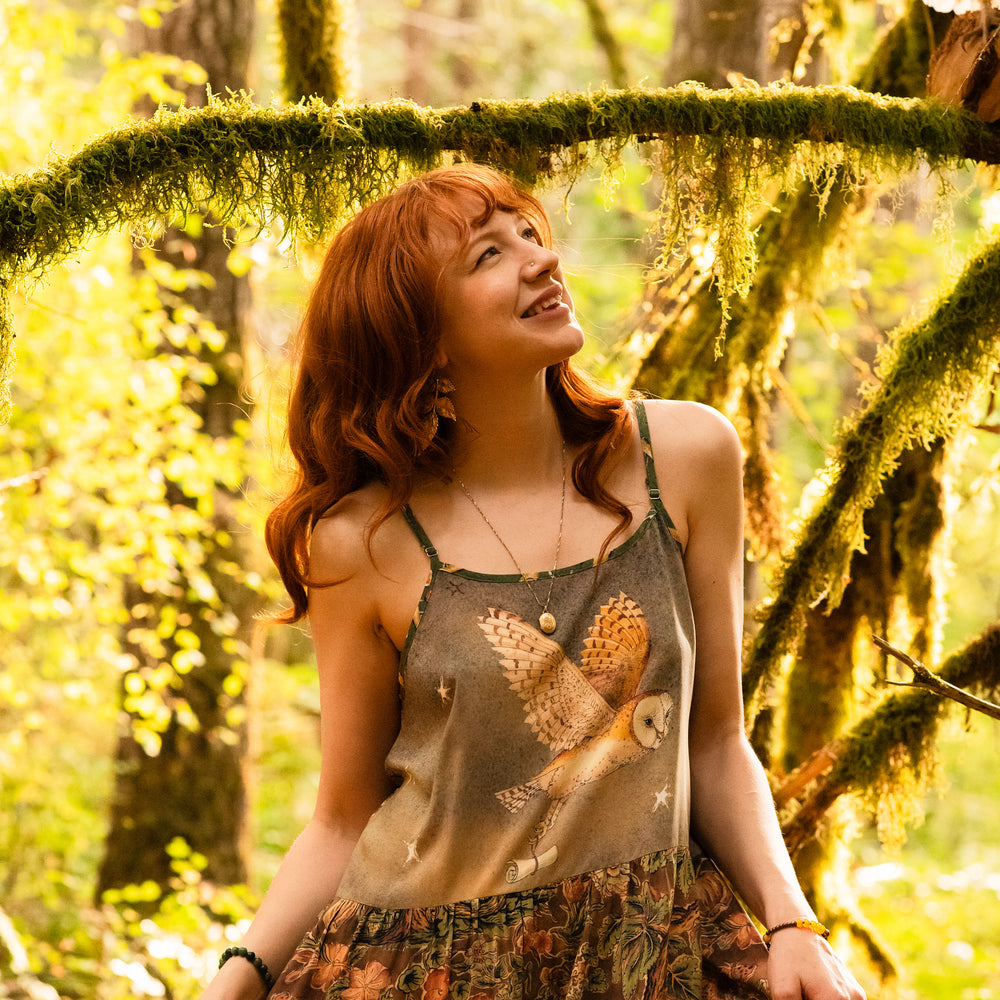 
                  
                    Model wearing a bamboo-viscose maxi length slip dress where even the unlikeliest of friends...a fox and a pheasant...find warmth in each other’s company. Created in collaboration with Charles van Sandwyck - Market of Stars
                  
                