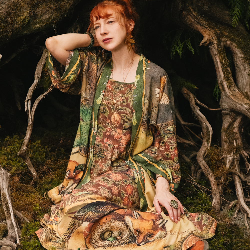 
                  
                    Model wearing a bamboo-viscose maxi length slip dress where even the unlikeliest of friends...a fox and a pheasant...find warmth in each other’s company. Created in collaboration with Charles van Sandwyck - Market of Stars
                  
                