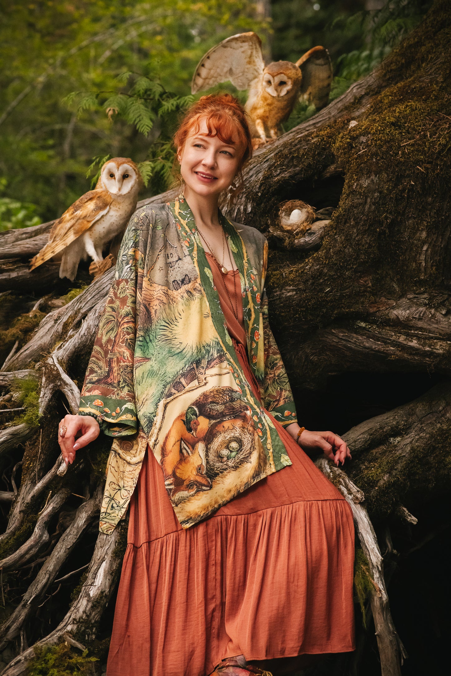 Model wearing a bamboo-viscose mid-length duster kimono robe where even the unlikeliest of friends...a fox and a pheasant...find warmth in each other’s company. Created in collaboration with Charles van Sandwyck - Market of Stars