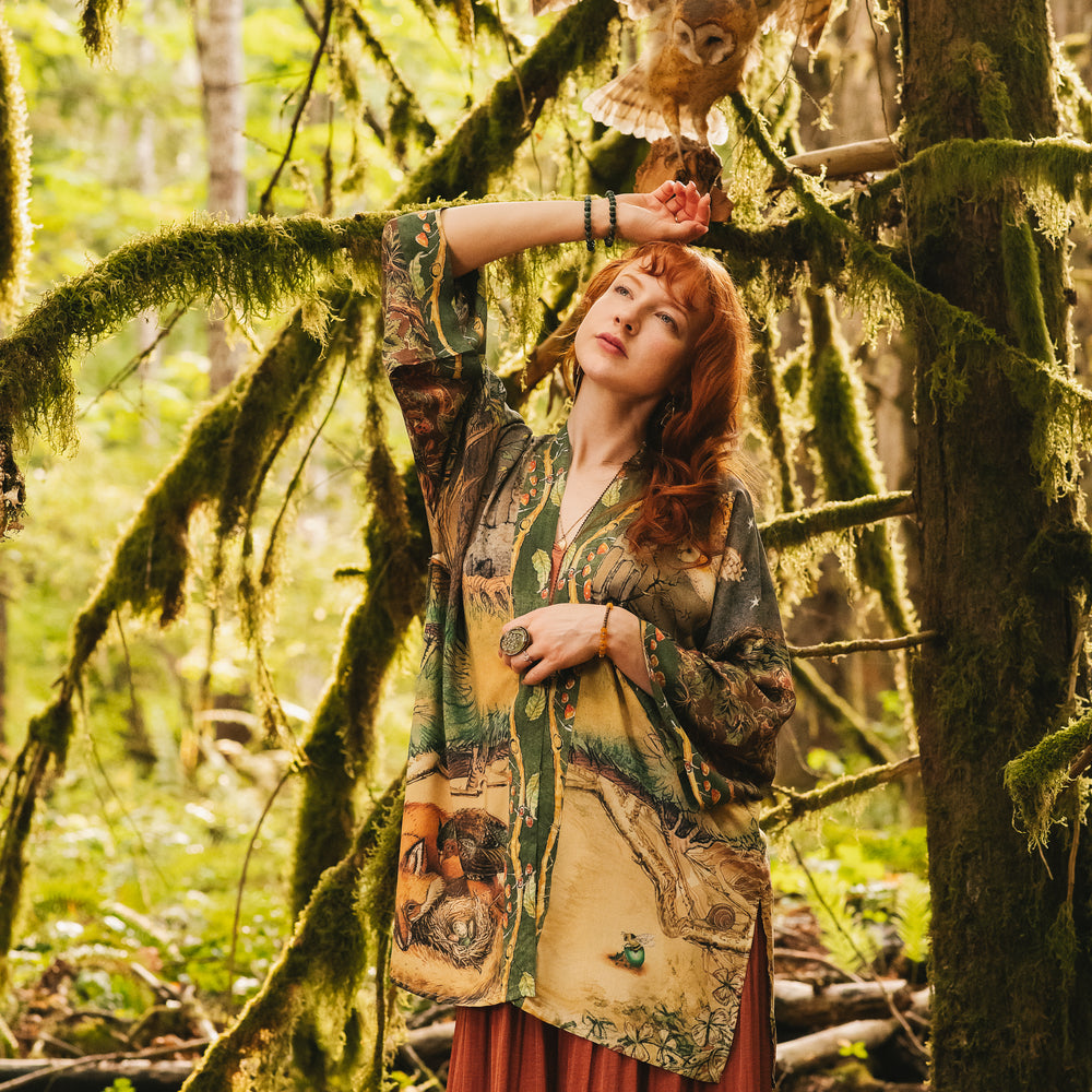 
                  
                    Model wearing a bamboo-viscose mid-length duster kimono robe where even the unlikeliest of friends...a fox and a pheasant...find warmth in each other’s company. Created in collaboration with Charles van Sandwyck - Market of Stars
                  
                