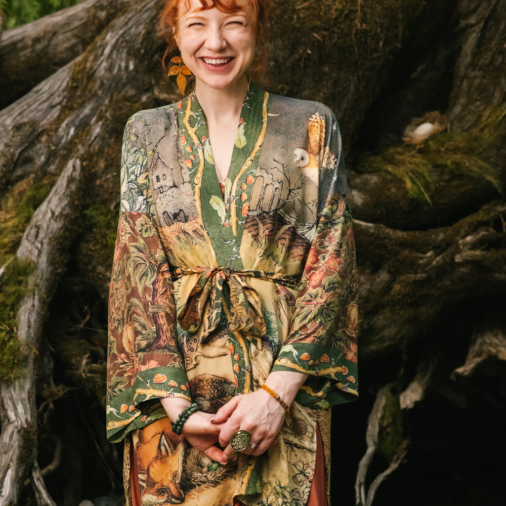 
                  
                    Model wearing a bamboo-viscose mid-length duster kimono robe where even the unlikeliest of friends...a fox and a pheasant...find warmth in each other’s company. Created in collaboration with Charles van Sandwyck - Market of Stars
                  
                