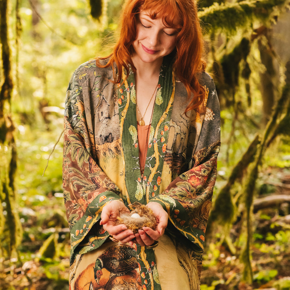 
                  
                    Model wearing a bamboo-viscose mid-length duster kimono robe where even the unlikeliest of friends...a fox and a pheasant...find warmth in each other’s company. Created in collaboration with Charles van Sandwyck - Market of Stars
                  
                