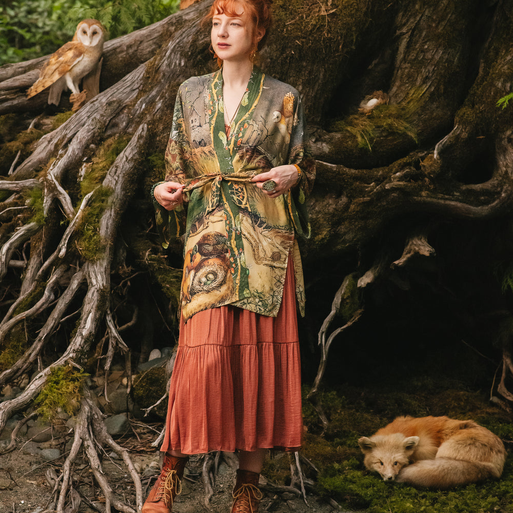 
                  
                    Model wearing a bamboo-viscose mid-length duster kimono robe where even the unlikeliest of friends...a fox and a pheasant...find warmth in each other’s company. Created in collaboration with Charles van Sandwyck - Market of Stars
                  
                