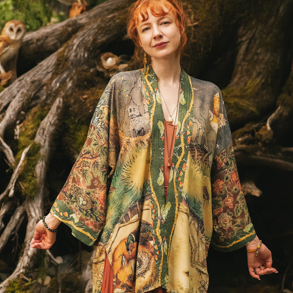 
                  
                    Model wearing a bamboo-viscose mid-length duster kimono robe where even the unlikeliest of friends...a fox and a pheasant...find warmth in each other’s company. Created in collaboration with Charles van Sandwyck - Market of Stars
                  
                