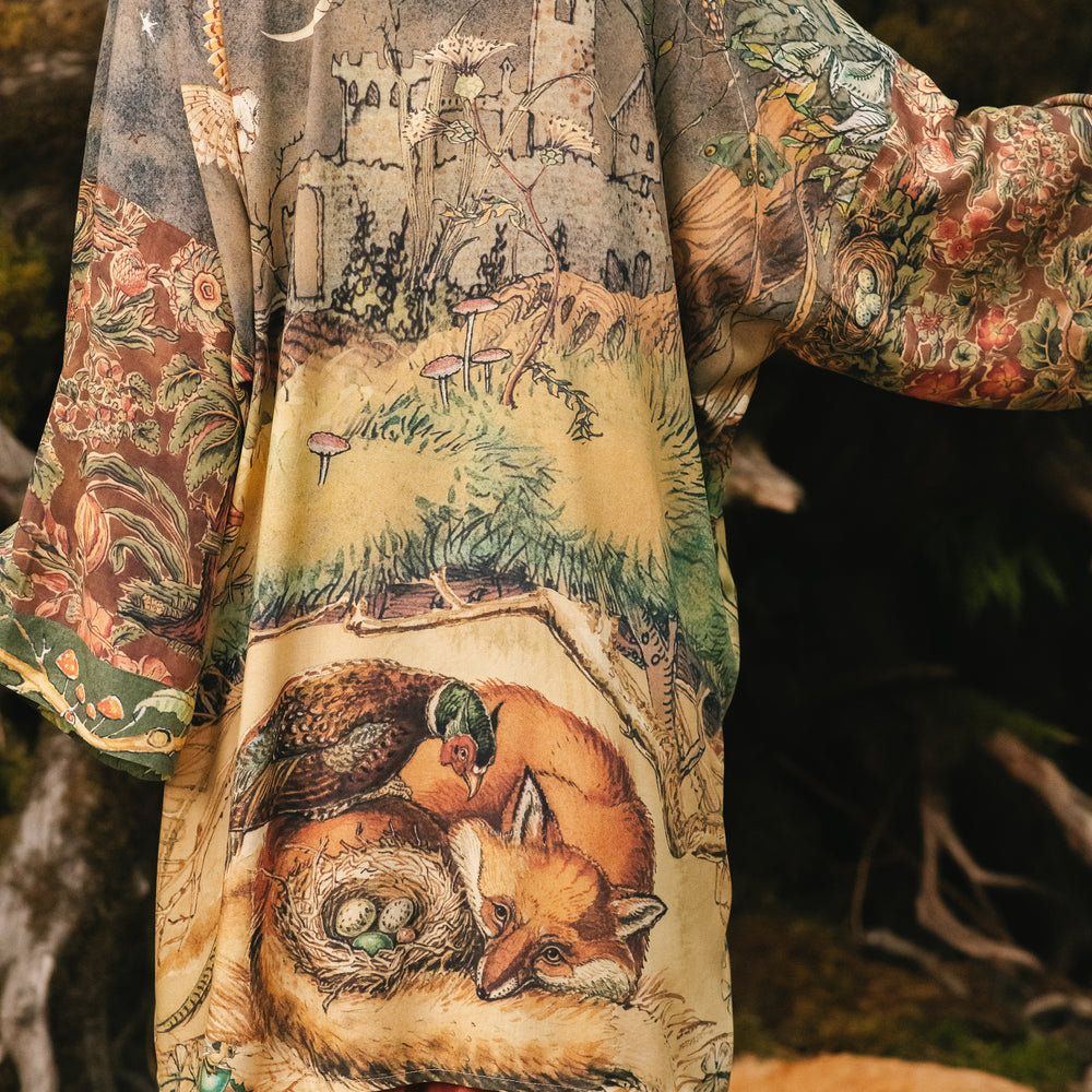 
                  
                    Model wearing a bamboo-viscose mid-length duster kimono robe where even the unlikeliest of friends...a fox and a pheasant...find warmth in each other’s company. Created in collaboration with Charles van Sandwyck - Market of Stars
                  
                