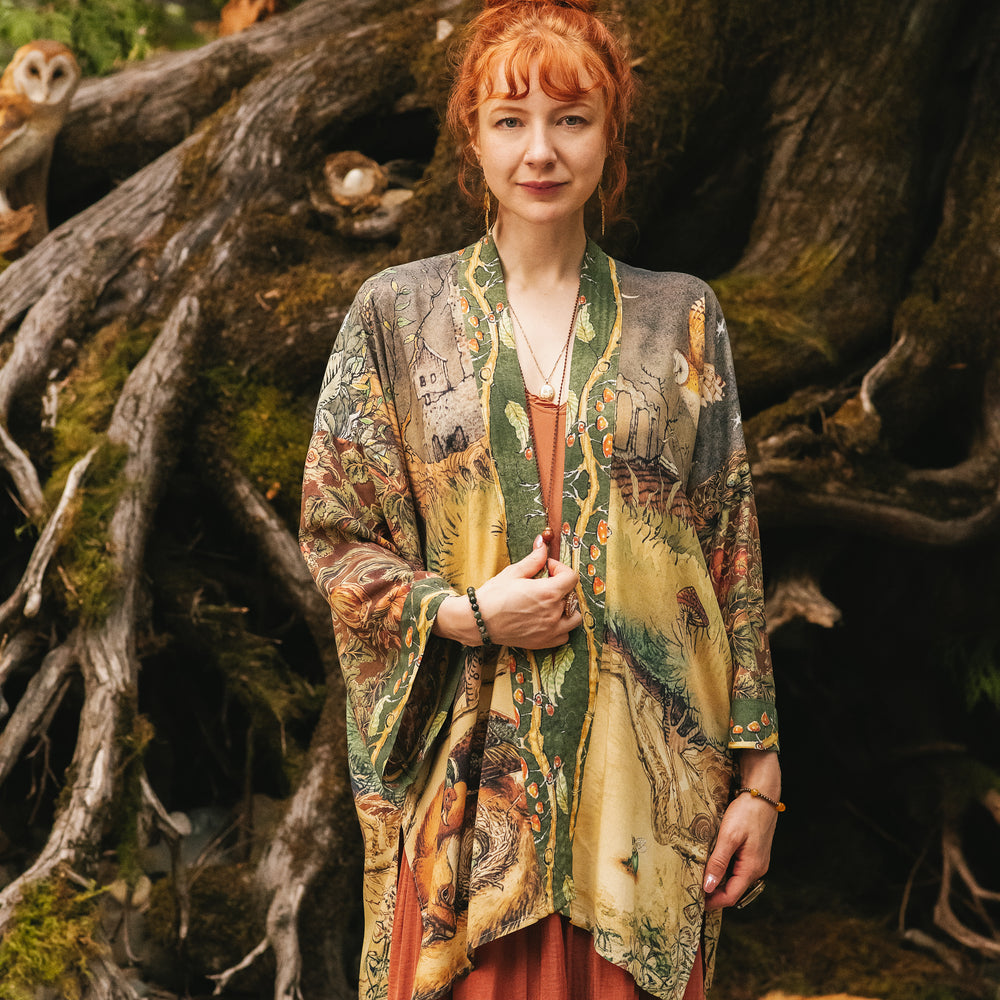 
                  
                    Model wearing a bamboo-viscose mid-length duster kimono robe where even the unlikeliest of friends...a fox and a pheasant...find warmth in each other’s company. Created in collaboration with Charles van Sandwyck - Market of Stars
                  
                